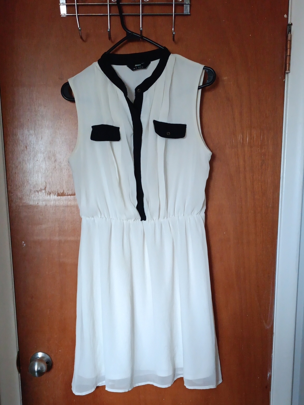 Sleeveless White Chiffon Dress with Black Trim and Pocket Detail